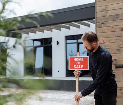 a man putting up a sign on your Maryland house after home staging