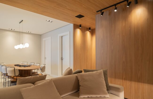 Modern comfortable living room with smart thermostat and subtle lighting - Home Systems