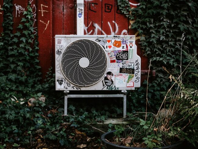 residential HVAC unit in a spring garden - why spring is a great time for duct cleaning